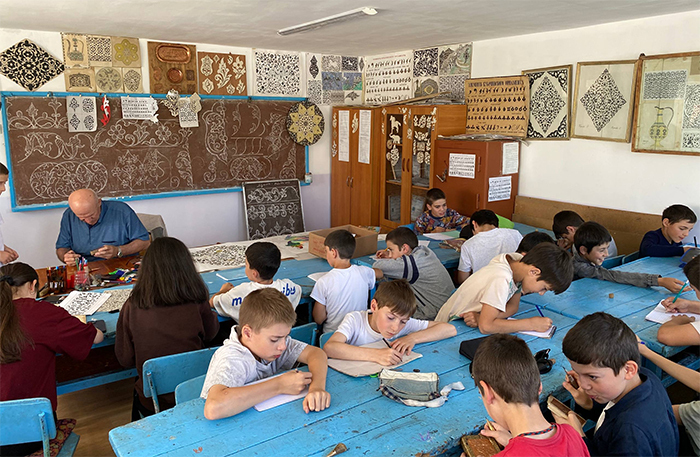 Children learning Kubachi art