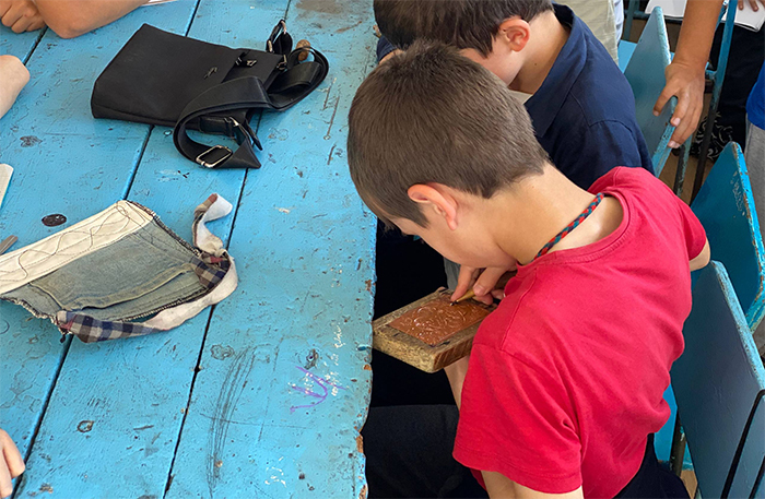 Children learning Kubachi art