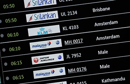 Табло с расписанием рейсов прибытия, в частности Malaysia Airlines полета MH17 в международном аэропорту в Сепанге 18 июля 2014.