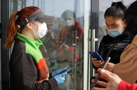 Проверка QR-кода у посетителей торгового центра.