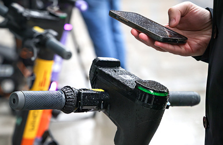 Electric scooters parked on a sidewalk in a residential area