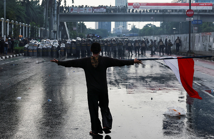 Демонстрант во время акции протеста против непомерных надбавок к зарплатам для членов индонезийского парламента у здания индонезийского парламента в Джакарте, Индонезия.