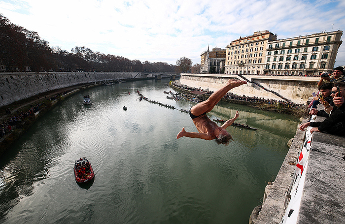 Традиционные новогодние прыжки в реку Тибр с моста Кавур в Риме. 